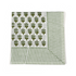 Green botanical block-printed cotton napkin in close-up.
