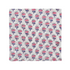 pink floral block-printed napkin laid flat on white background.