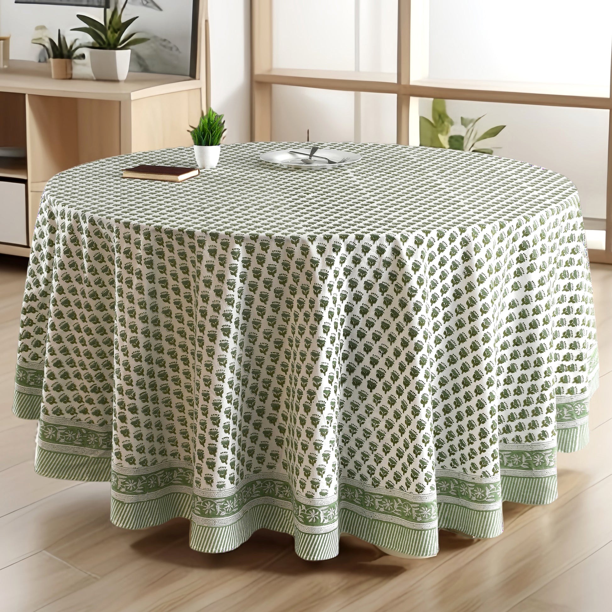 a round table with a green tablecloth on it
