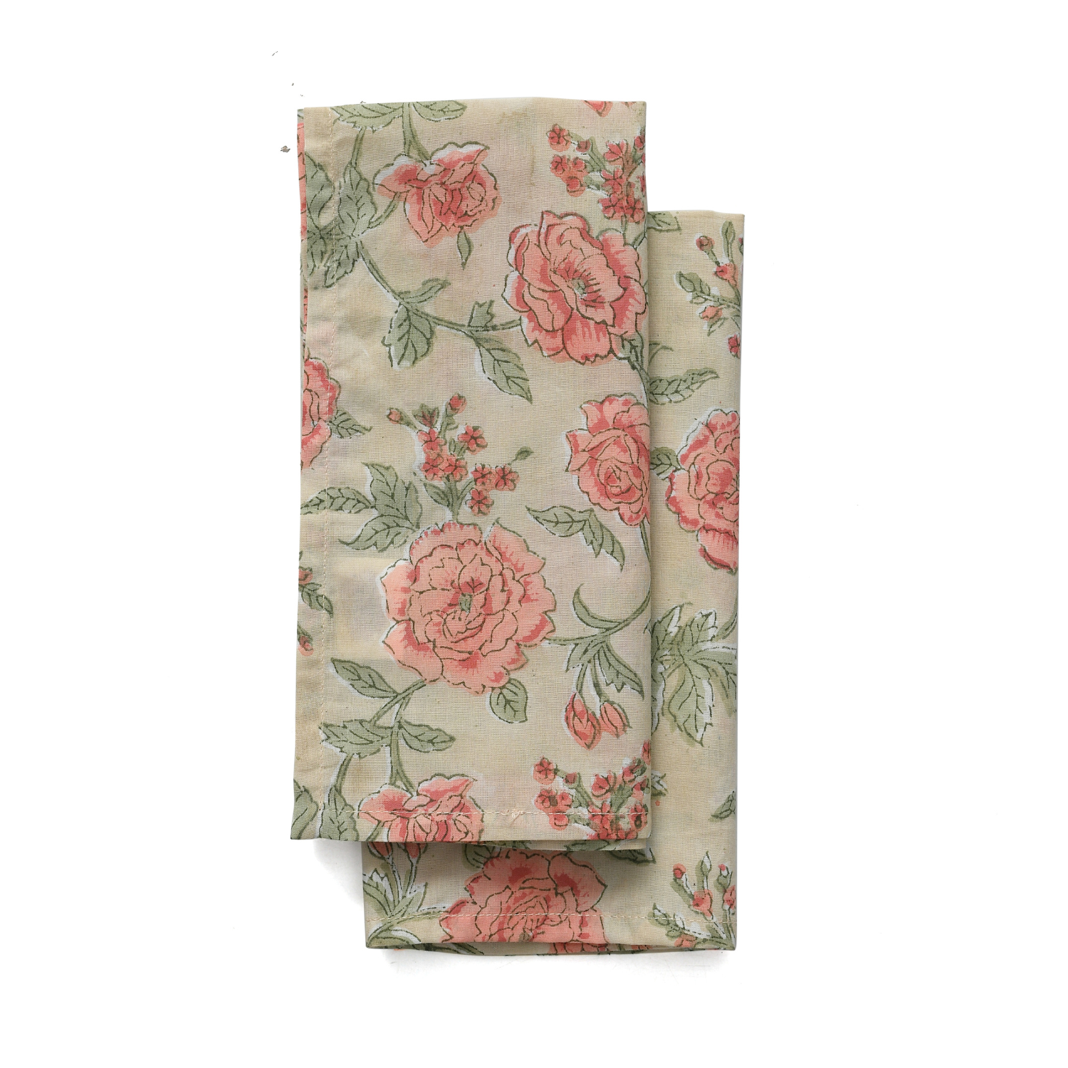 A set of folded cotton cloth napkins with a floral pattern in shades of pink and green on a beige background.