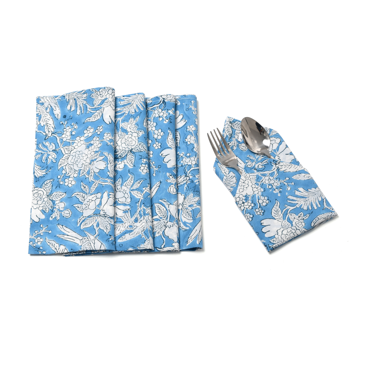 Flat lay of three folded blue floral napkins with one holding silverware.