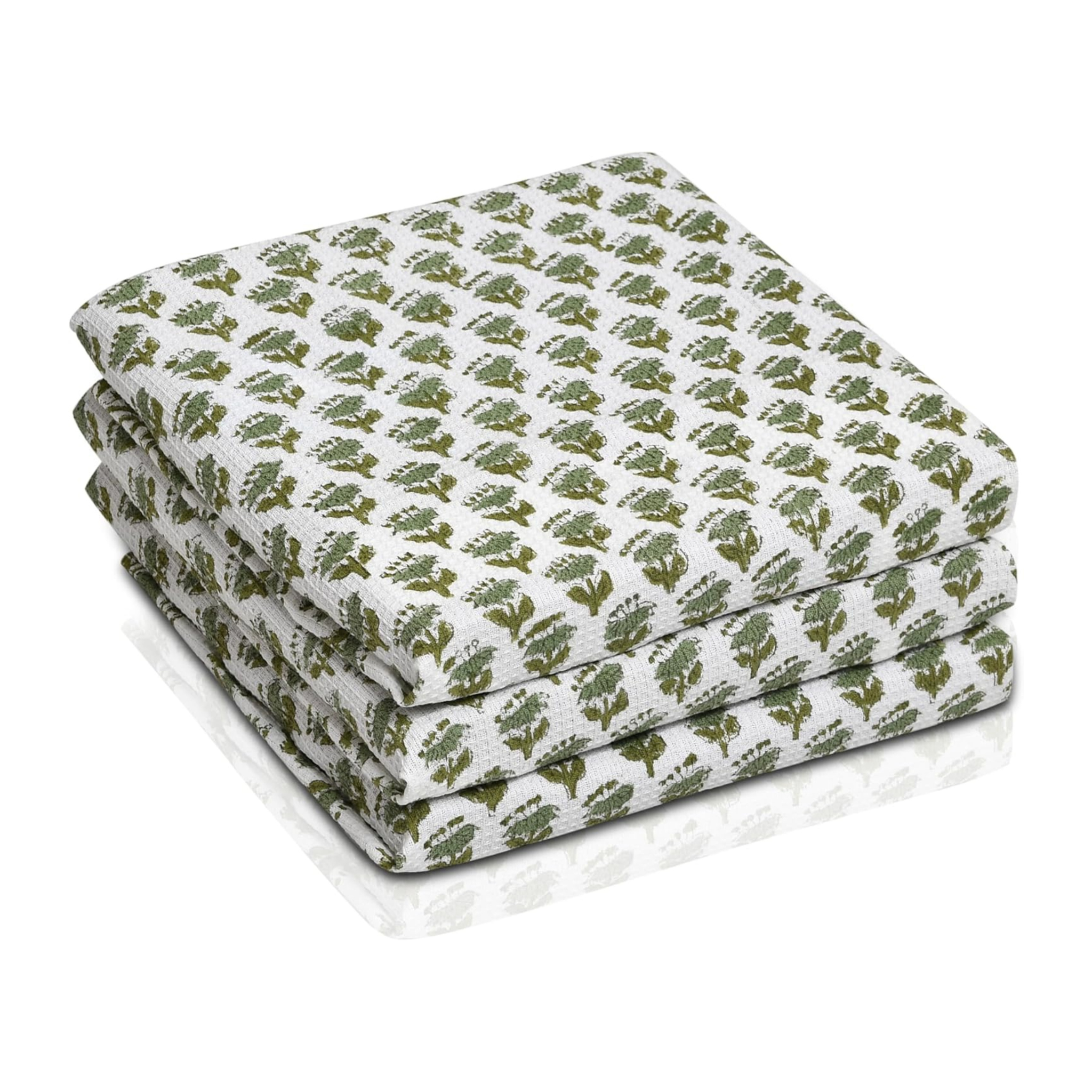 Set of three folded green waffle cotton towels with floral hand block print