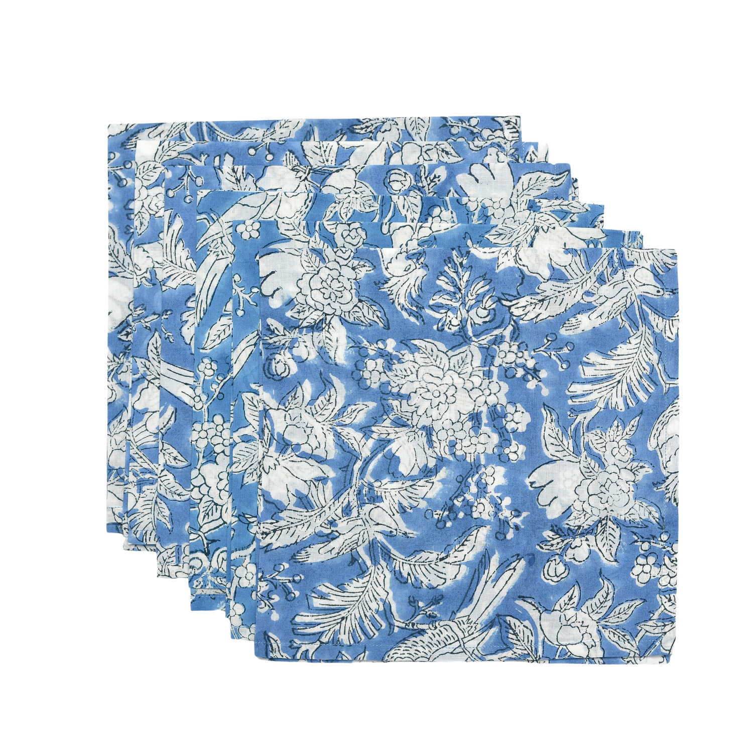 Set of six blue and white floral cloth napkins fanned out on white surface.