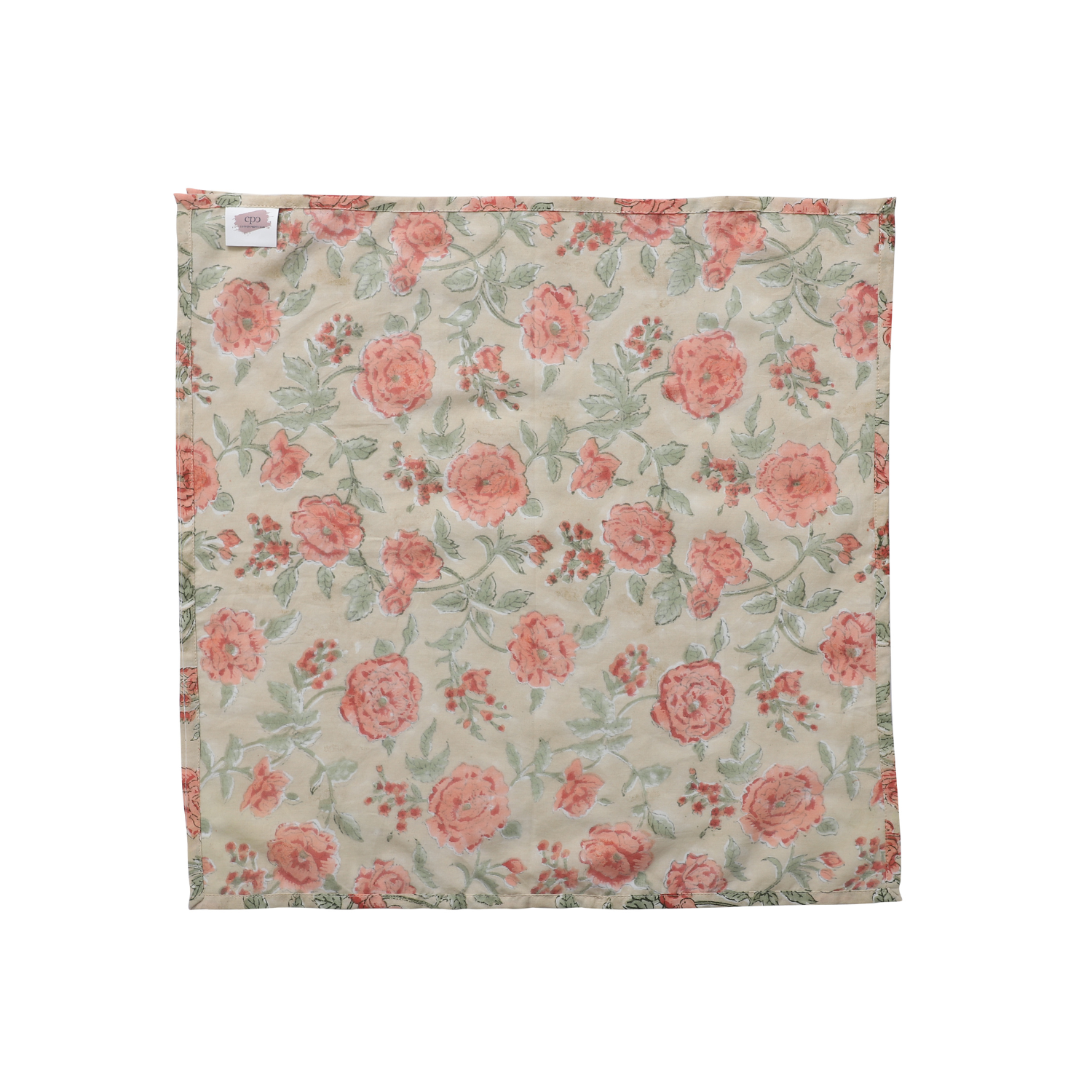 Single pink and tan floral napkin folded under silverware on a white plate.