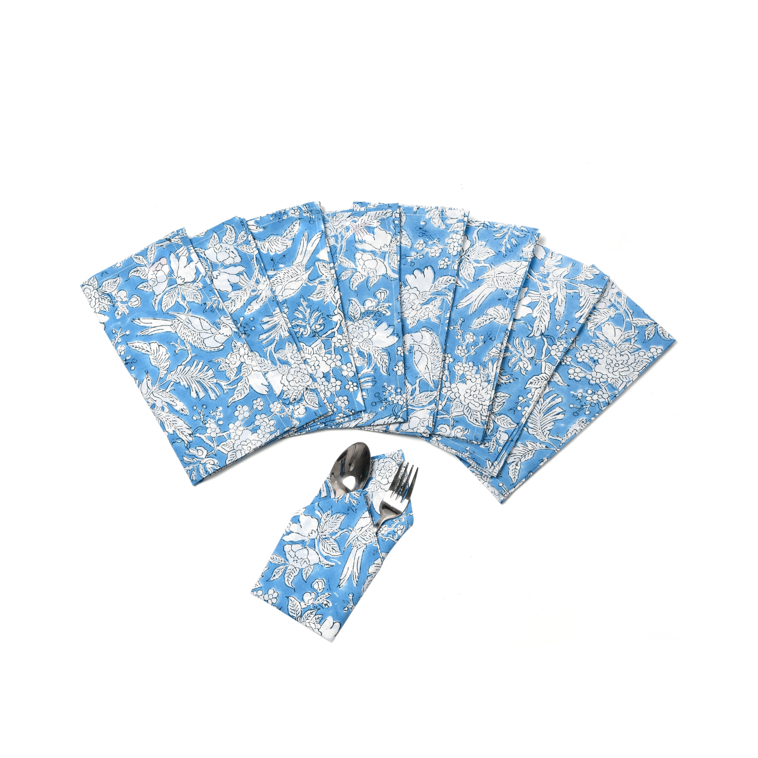 Six blue floral napkins displayed in a fan arrangement with a single folded one in the center holding silverware.