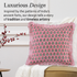 pink floral pillow with beige fringe trim displayed against a soft beige background showing fabric details.