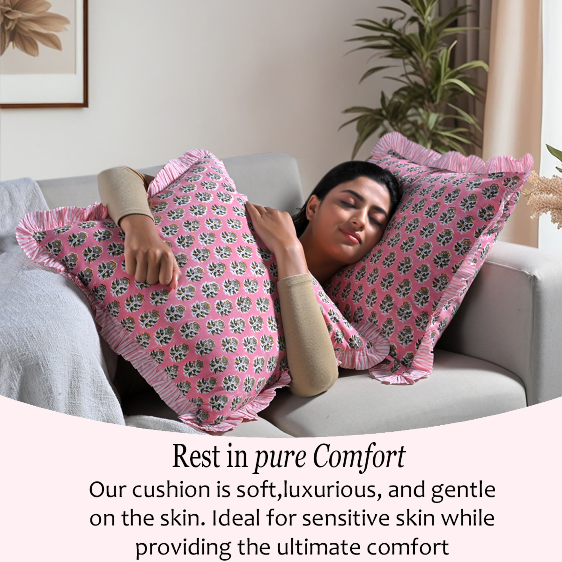 Woman relaxing on a couch with two bohemian floral pillows for comfort and cozy home décor.