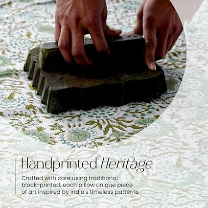 Hand printing a pillow with traditional block-printing technique on a patterned fabric background.