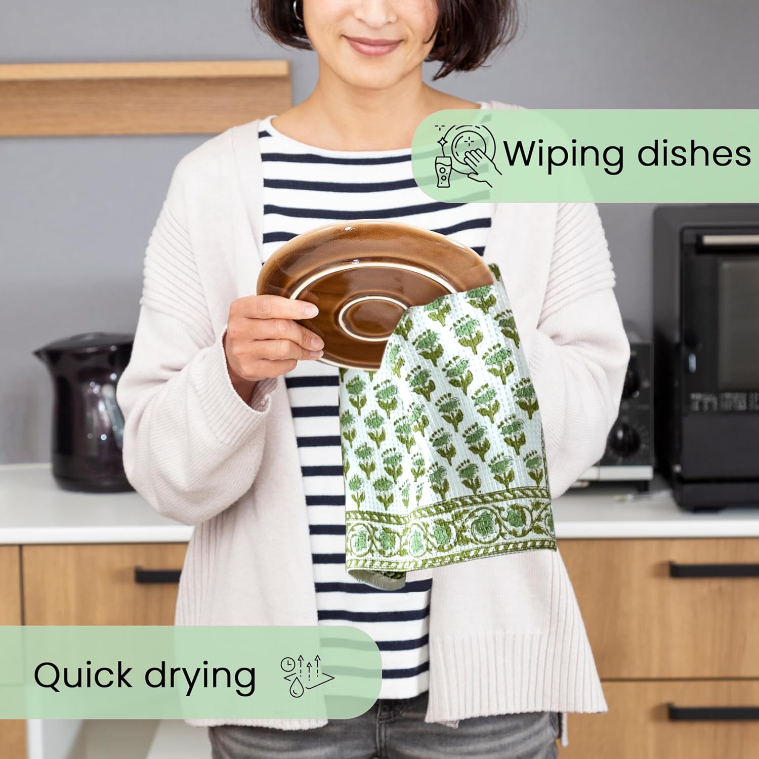 Person drying dishes with green hand block printed towel