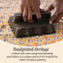 Hand pressing down on a handcrafted cotton pillow cover, highlighting artisanal craftsmanship and texture.