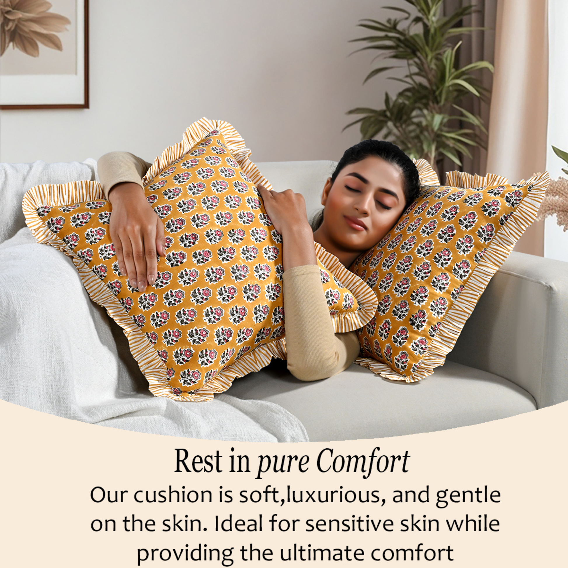 Woman relaxing on a couch with two bohemian floral pillows for comfort and cozy home décor