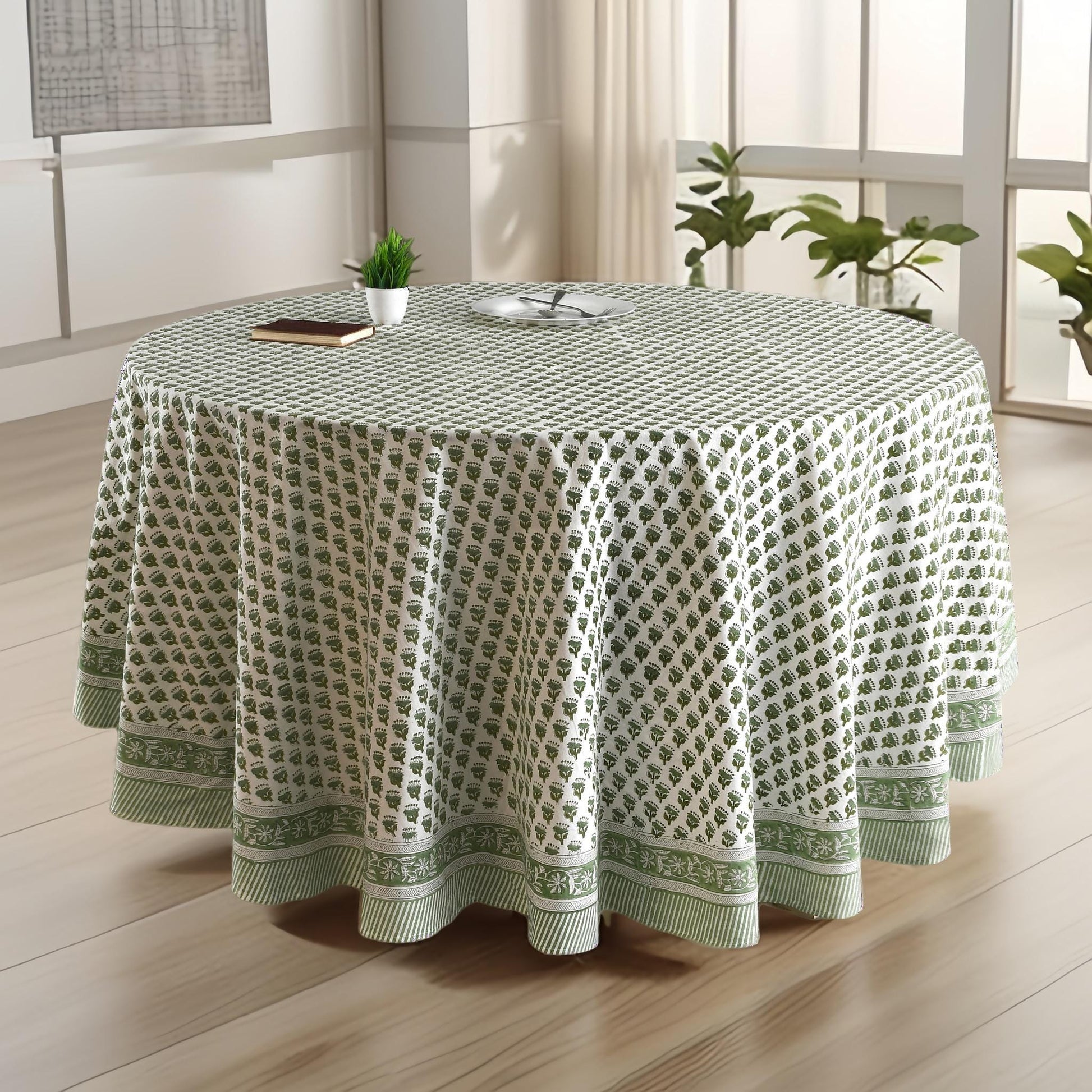 a round table with a green tablecloth on it