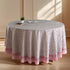 a round table with a pink and white tablecloth