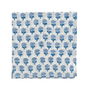blue floral block-printed napkin laid flat on white background.

