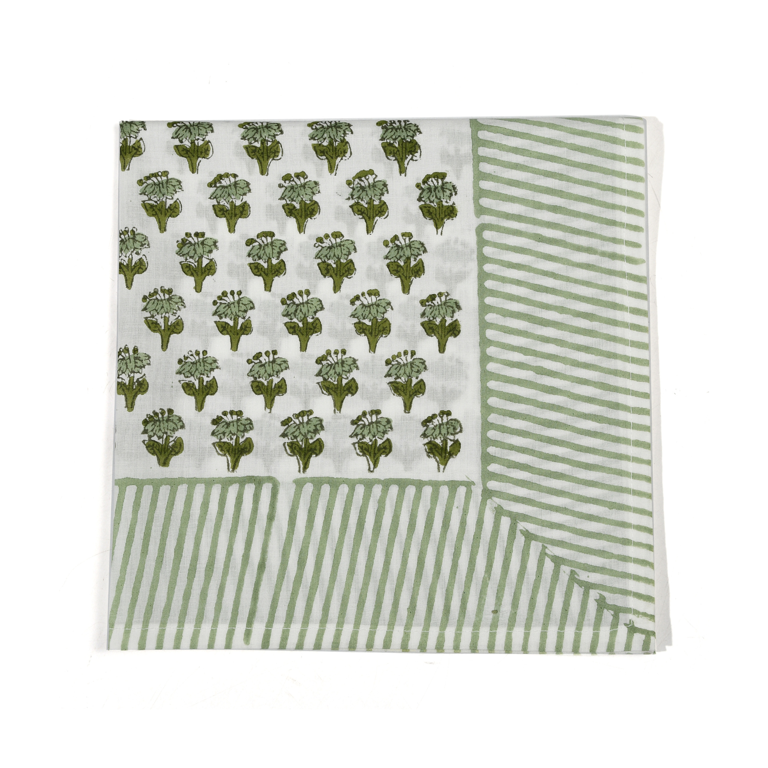 Green botanical block-printed cotton napkin in close-up.

