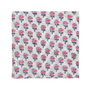 pink floral block-printed napkin laid flat on white background.

