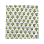 green floral block-printed napkin laid flat on white background.

