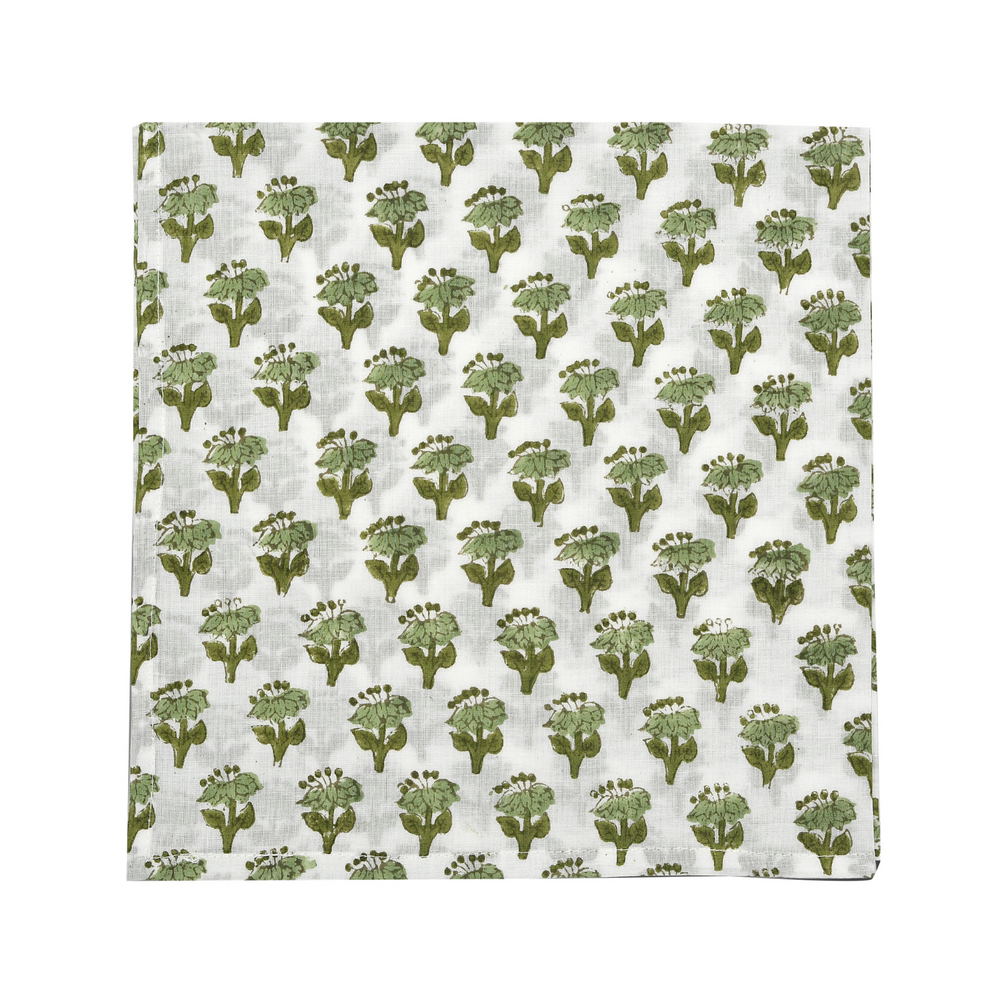 green floral block-printed napkin laid flat on white background.

