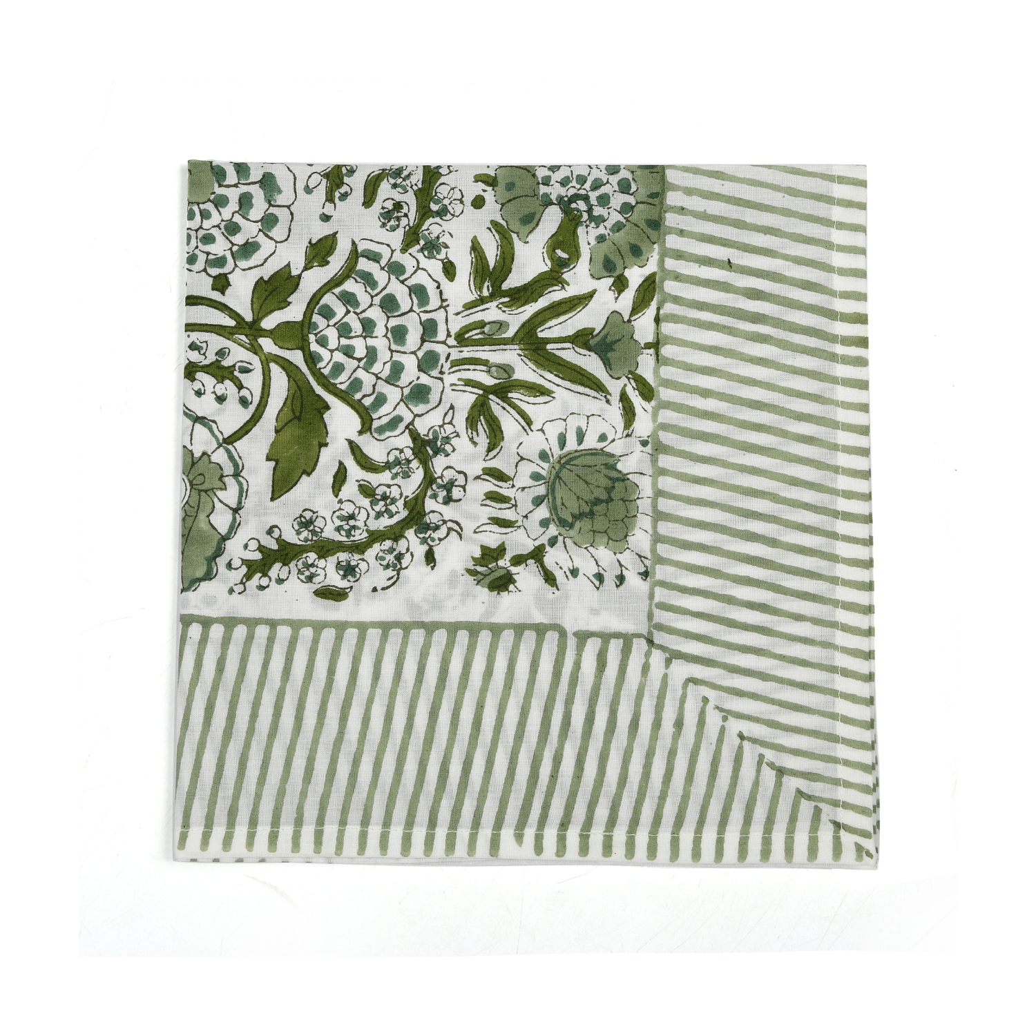 Green botanical block-printed cotton napkin in close-up.

