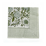 Green botanical block-printed cotton napkin in close-up.

