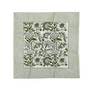 Green botanical block-printed cotton napkin in close-up.

