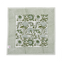 Green botanical block-printed cotton napkin in close-up.

