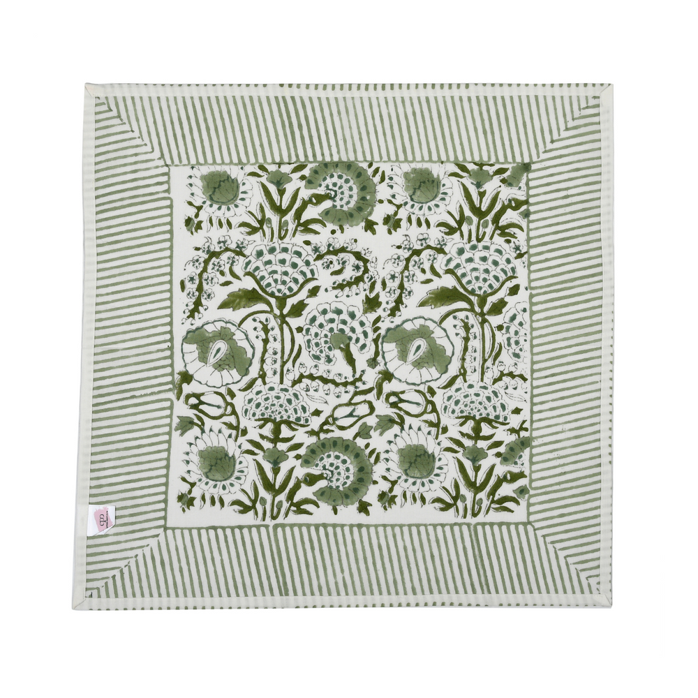Green botanical block-printed cotton napkin in close-up.

