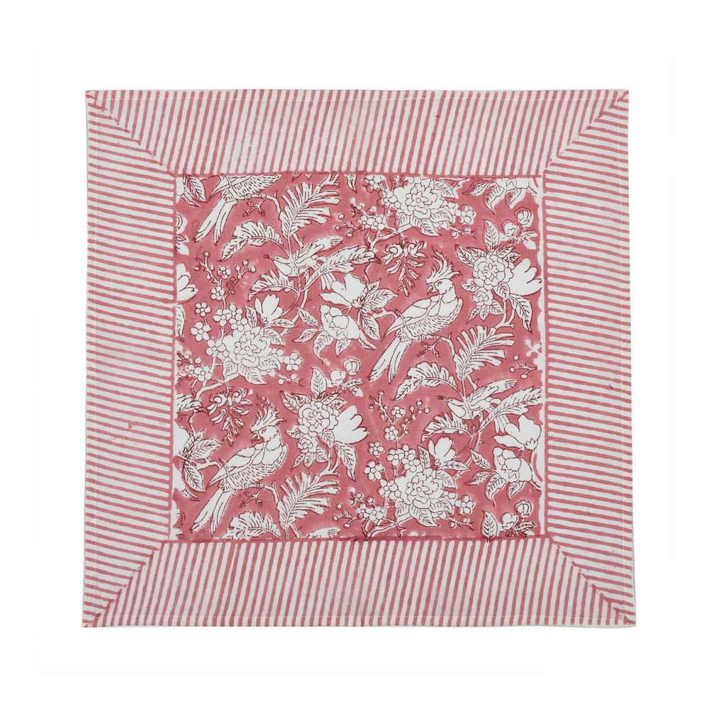 pink botanical block-printed cotton napkin in close-up.

