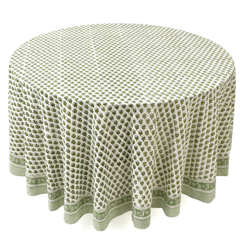 a round table with a green tablecloth on it
