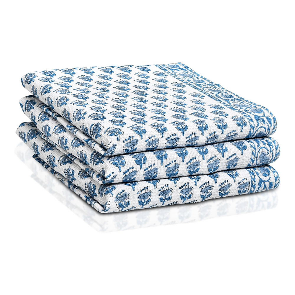 Set of three folded Apatite Blue waffle cotton towels with floral hand block print
