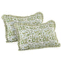 Two green floral patterned pillows with ruffled edges on a white background