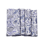 A set of folded cotton cloth napkins with a hand-printed floral and geometric design in indigo blue on a white background.