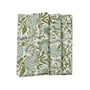 A set of folded cotton cloth napkins with a green floral pattern on a white background.