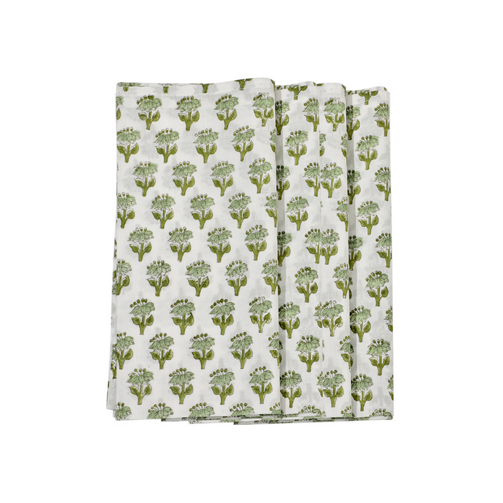 A set of folded emerald green cotton cloth napkins with a floral block print design on a white background.