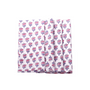 A set of folded cotton cloth napkins with a hand-printed floral and geometric design in pink and purple colors on a white background.