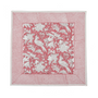 pink botanical block-printed cotton napkin in close-up.

