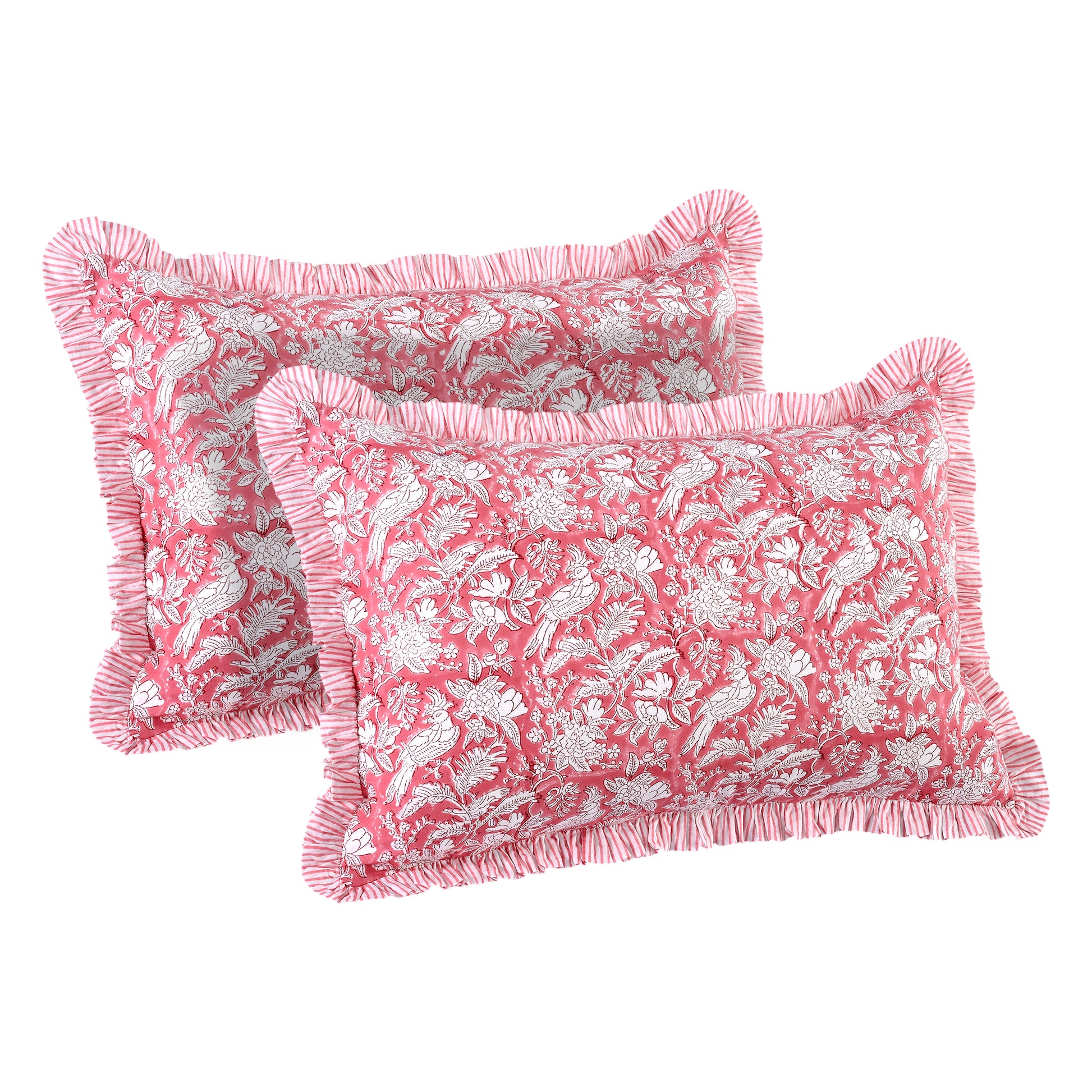 Two pink decorative pillows with white floral and bird pattern on a white background