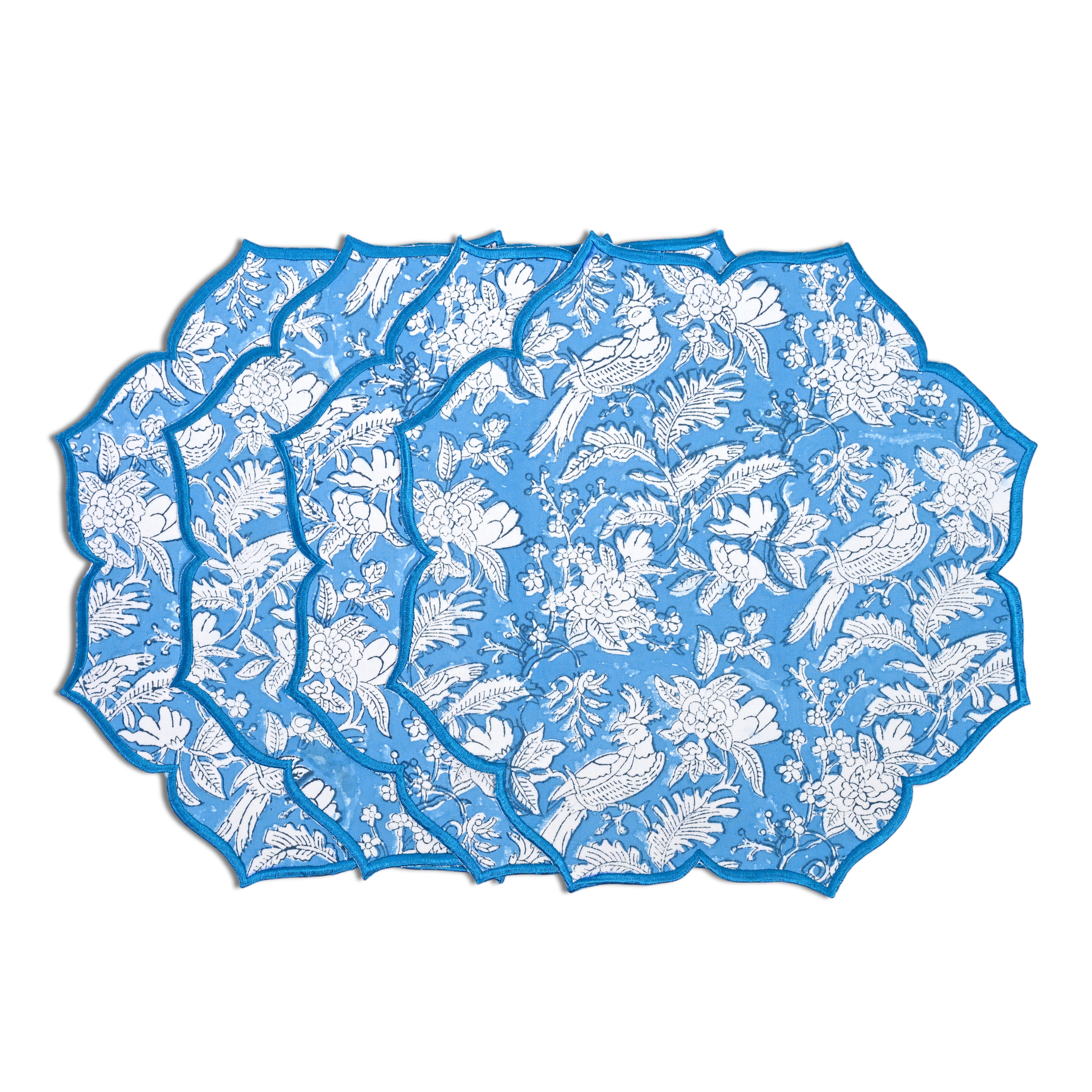 Decorative cotton placemat in sapphire blue with scalloped edges