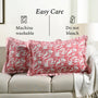 Decorative pillows with floral pattern on a sofa, featuring washing and care instructions.