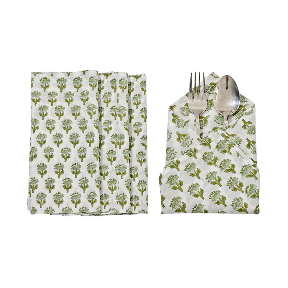 Six green floral napkins displayed in a fan arrangement with a single folded one in the center holding silverware.
