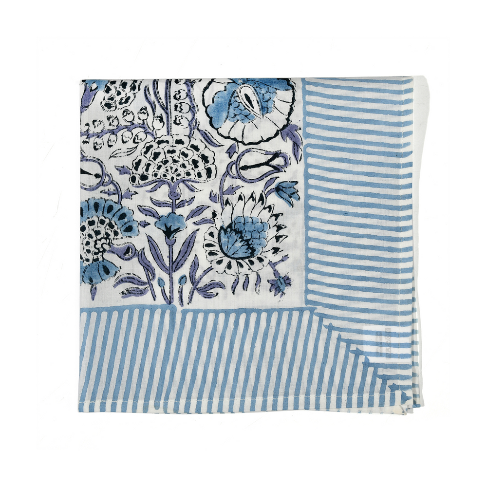blue botanical block-printed cotton napkin in close-up.

