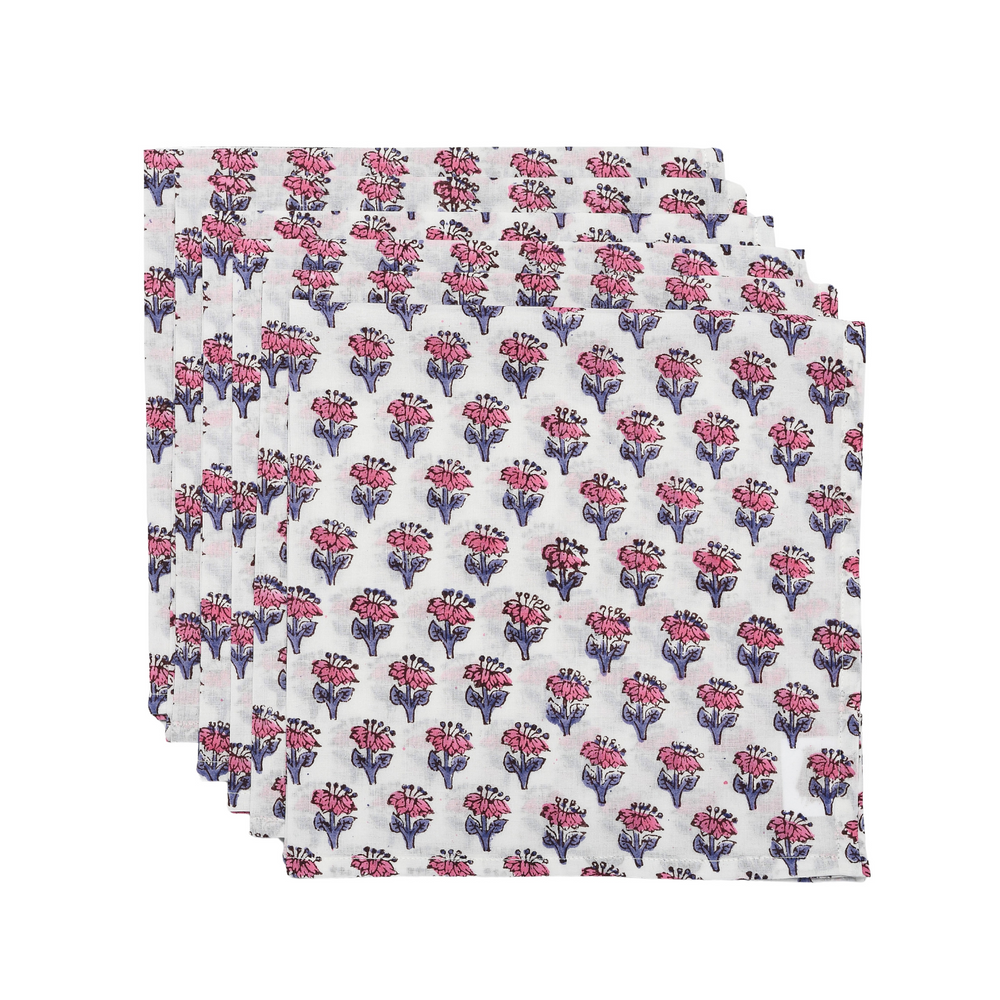 Stack of neatly flat pink and white floral napkins on a white background.