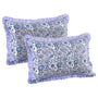Two decorative pillows with floral pattern and purple ruffle on a white background