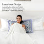 Woman sitting on a bed with decorative pillows, text about luxurious design inspired by India's ancient forts.