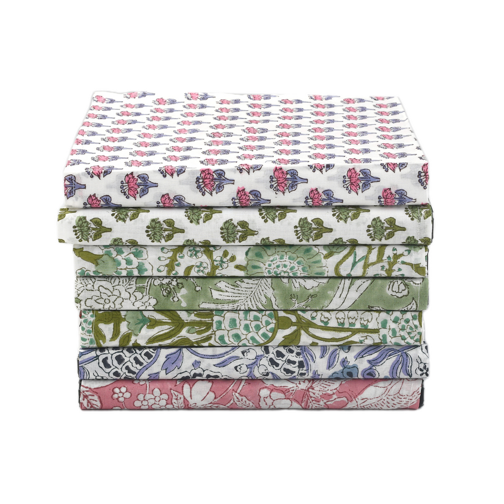 Rainbow fan layout of colorful block-printed napkins arranged in a circle.

