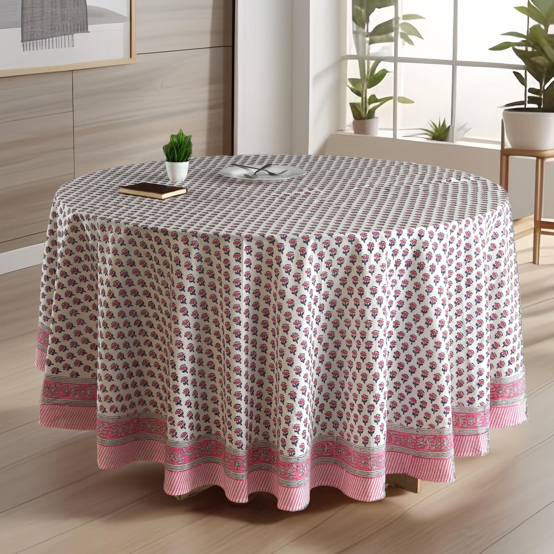 a round table covered with a pink and white tablecloth