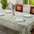 Olive Green Cotton Tablecloth on Farmhouse Kitchen Table with Chairs, Plates, and Silverware