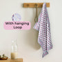pink kitchen towel hanging from hook in a modern kitchen