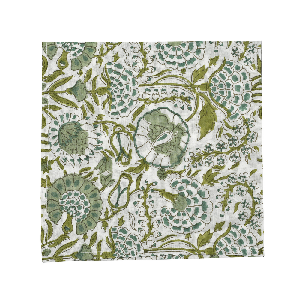 Green botanical block-printed cotton napkin in close-up.

