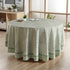 a round table with a green tablecloth on it